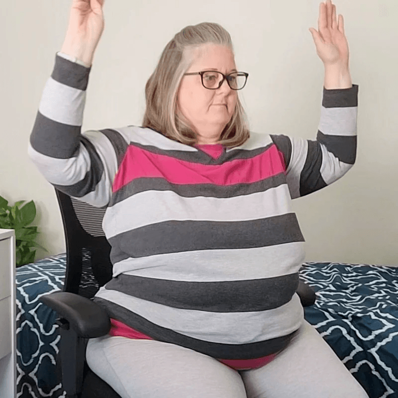 Woman stretching at her desk